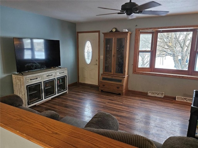 living room featuring ceiling fan and dark hardwood / wood-style floors