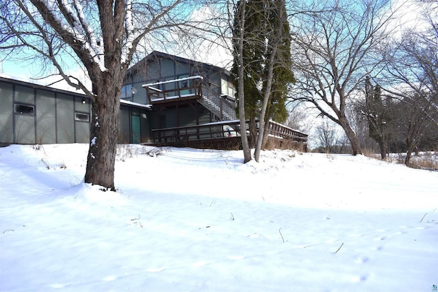 snow covered property featuring a wooden deck