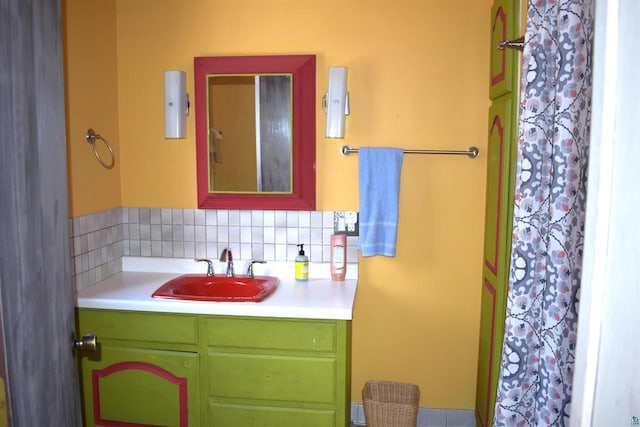 bathroom featuring vanity and tasteful backsplash