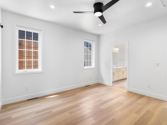 unfurnished bedroom with ceiling fan, light hardwood / wood-style floors, and ensuite bath