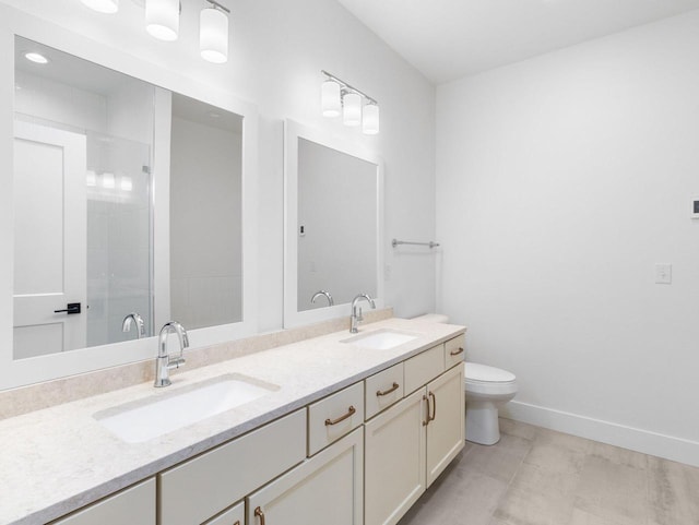 bathroom featuring an enclosed shower, vanity, and toilet