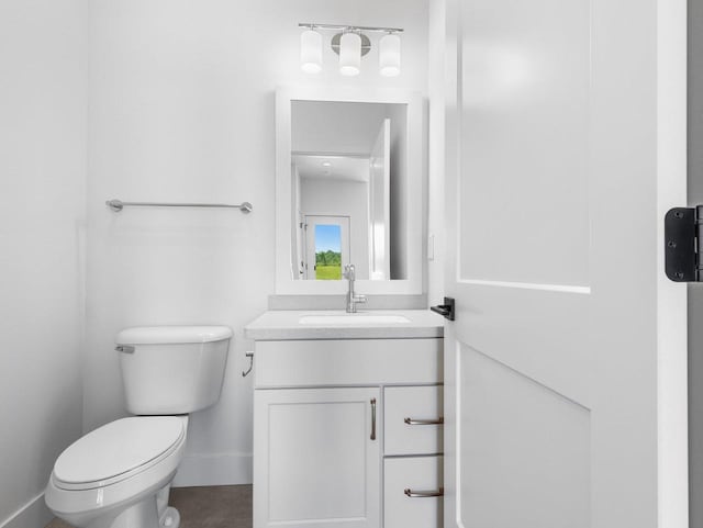 bathroom featuring toilet and vanity