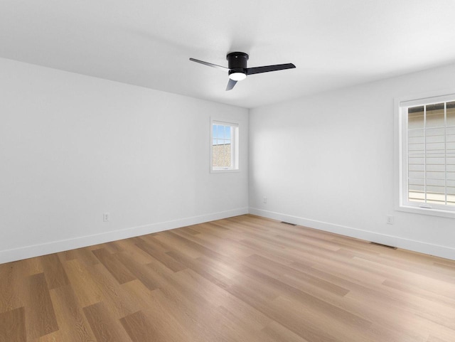 empty room featuring ceiling fan and light hardwood / wood-style flooring