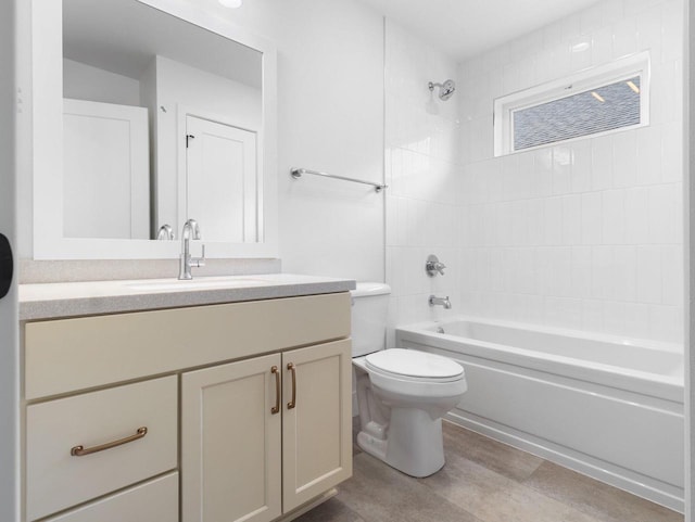 full bathroom featuring toilet, vanity, and tiled shower / bath