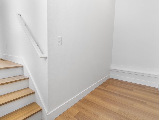 stairway featuring wood-type flooring