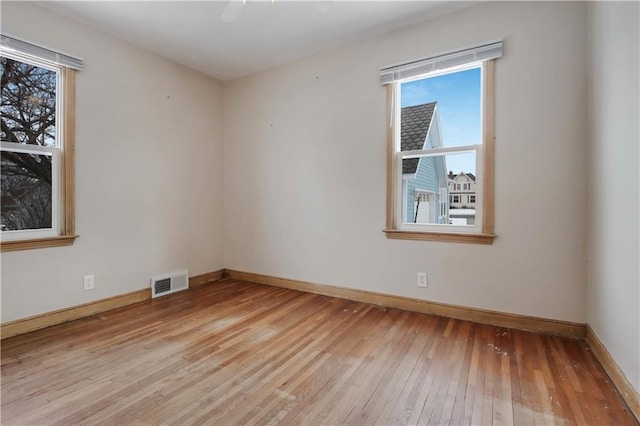 unfurnished room with light wood-type flooring