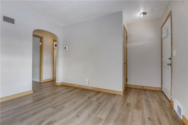 empty room with light hardwood / wood-style flooring