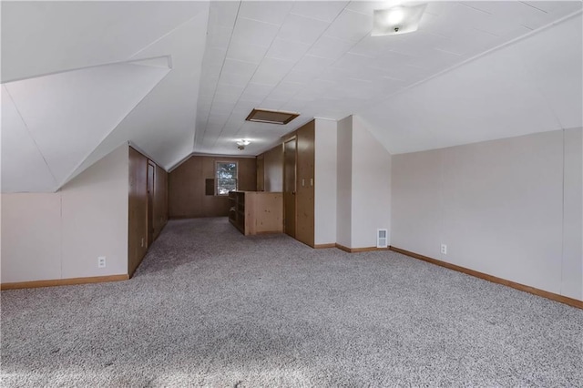 bonus room with light carpet and lofted ceiling