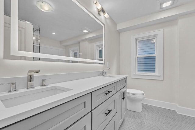 bathroom featuring toilet and vanity