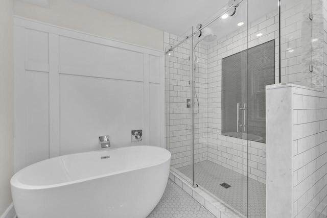 bathroom with separate shower and tub and tile patterned flooring