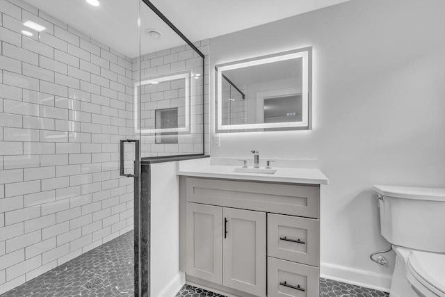 bathroom with a shower with shower door, tile patterned floors, toilet, and vanity