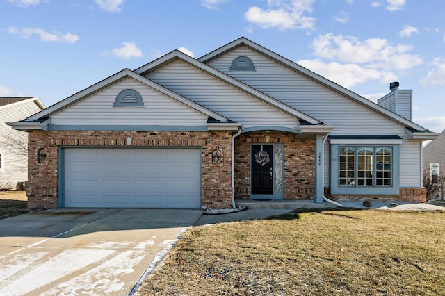 view of front of property featuring a front yard and a garage