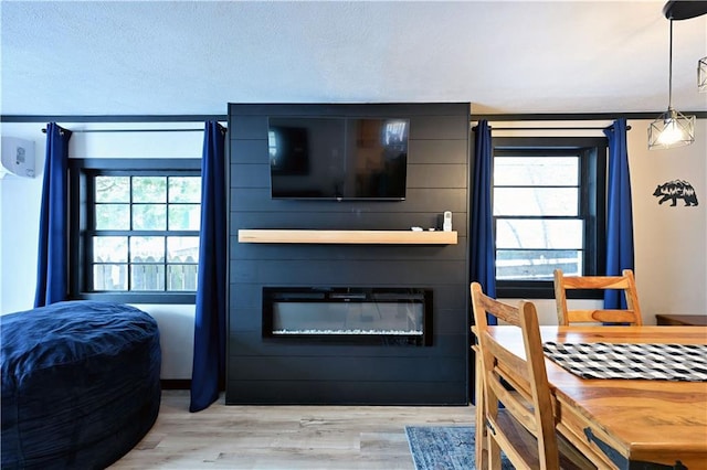 bedroom with a fireplace and light hardwood / wood-style flooring