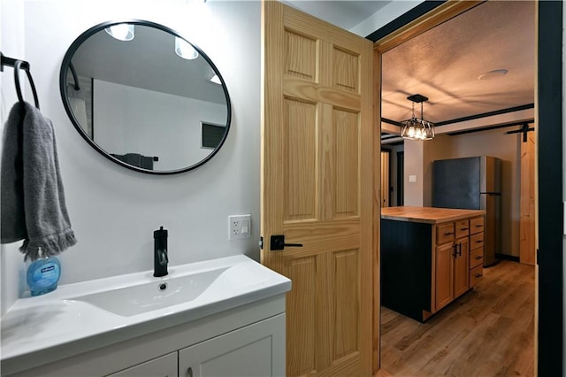 bathroom with vanity and wood-type flooring