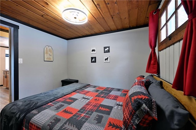 bedroom with wood ceiling and hardwood / wood-style floors