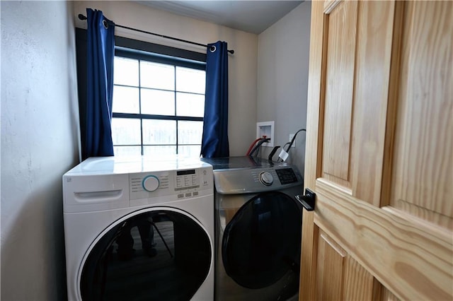 laundry room featuring washing machine and clothes dryer