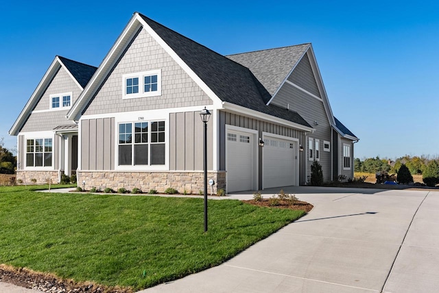 craftsman house featuring a garage and a front yard