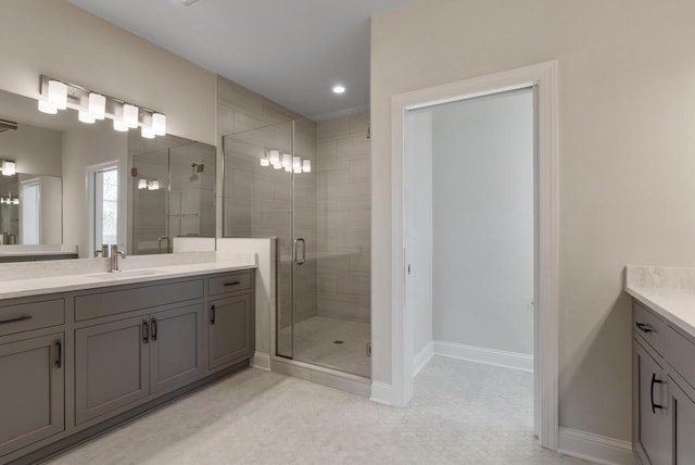 bathroom featuring an enclosed shower and vanity