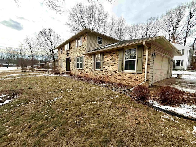 view of side of home with a lawn and a garage