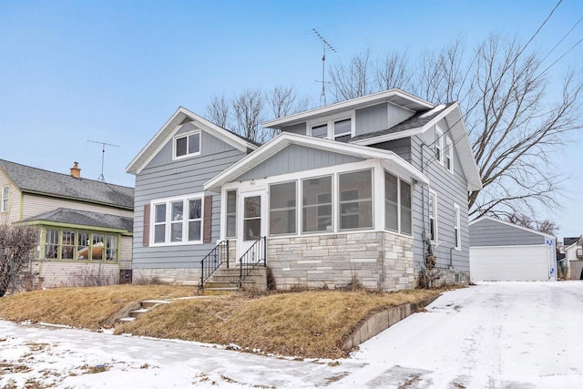 view of front of property with a garage and an outbuilding