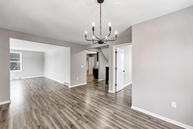 interior space featuring wood-type flooring and a chandelier