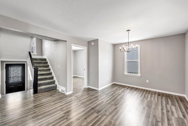 empty room featuring hardwood / wood-style floors and a notable chandelier