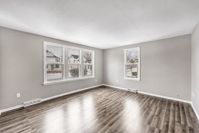 unfurnished room with dark hardwood / wood-style flooring