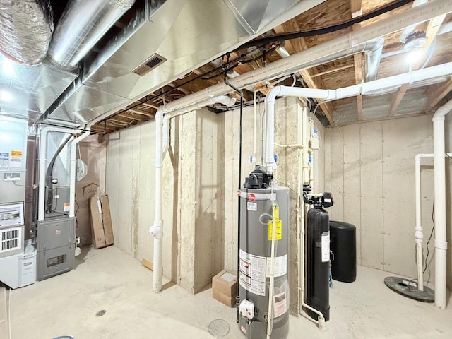 basement featuring heating unit and water heater