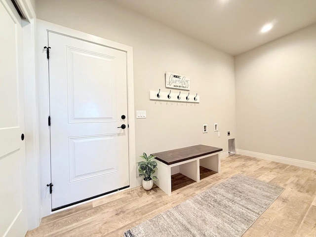 washroom featuring washer hookup, electric dryer hookup, and hardwood / wood-style flooring