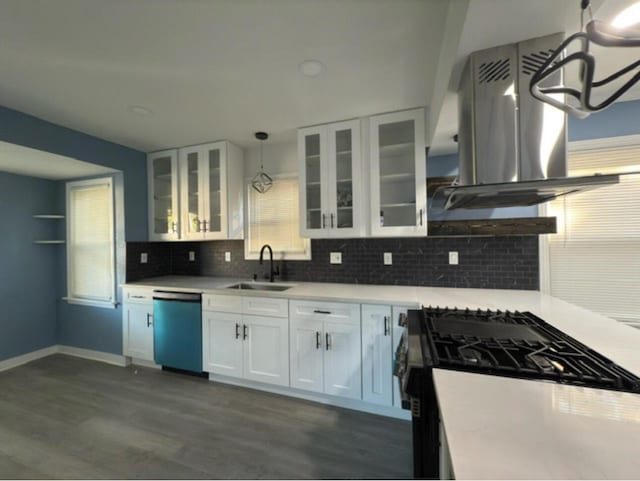 kitchen featuring dishwasher, gas stove, pendant lighting, sink, and island range hood