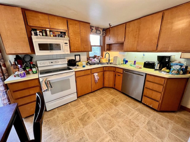 kitchen featuring sink and white appliances