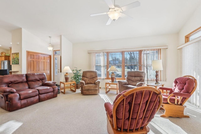 carpeted living room featuring lofted ceiling and ceiling fan