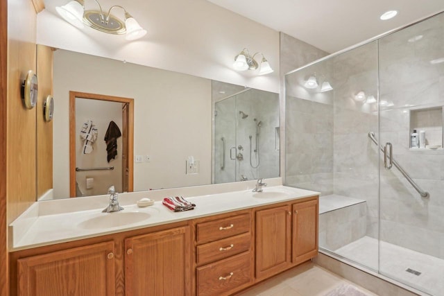 bathroom featuring walk in shower, vanity, and tile patterned flooring