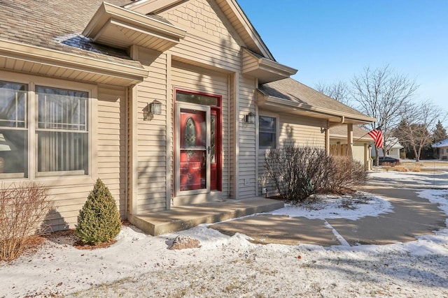 view of snow covered property entrance