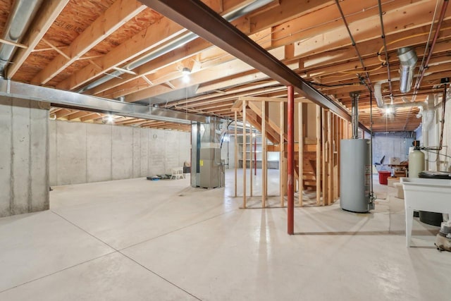 basement featuring heating unit and water heater