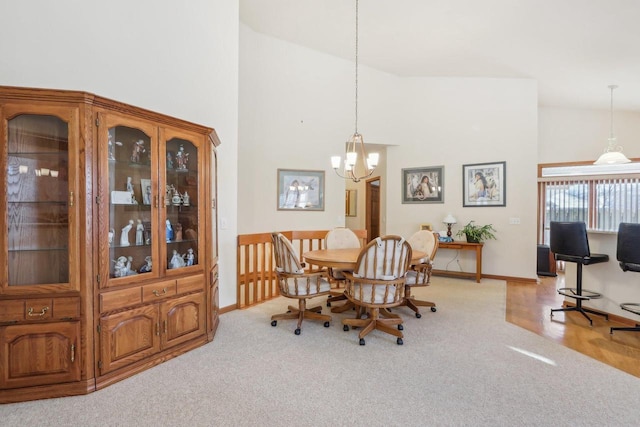 dining room featuring high vaulted ceiling, light colored carpet, and a notable chandelier