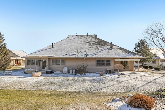 back of property with central air condition unit and a patio