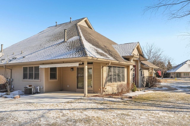 rear view of property with central AC unit and a patio