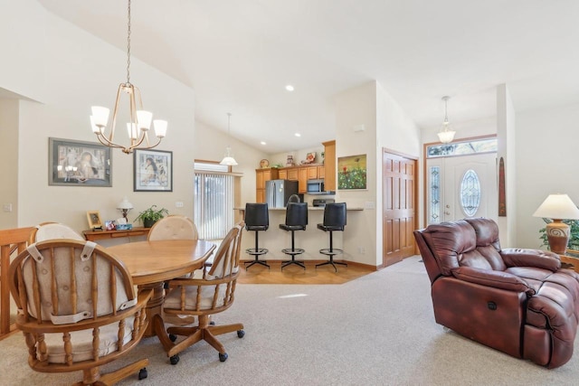 dining room featuring high vaulted ceiling and a chandelier