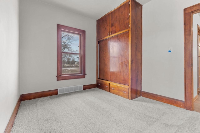 unfurnished bedroom featuring light colored carpet