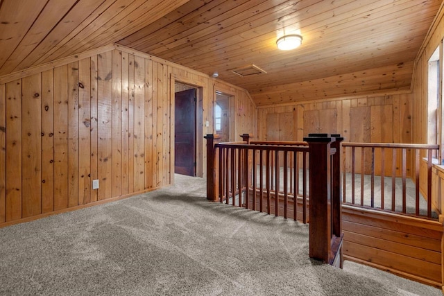 bonus room featuring carpet floors, wooden walls, wood ceiling, and vaulted ceiling