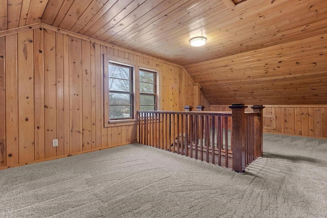 bonus room with vaulted ceiling, carpet, wood ceiling, and wooden walls