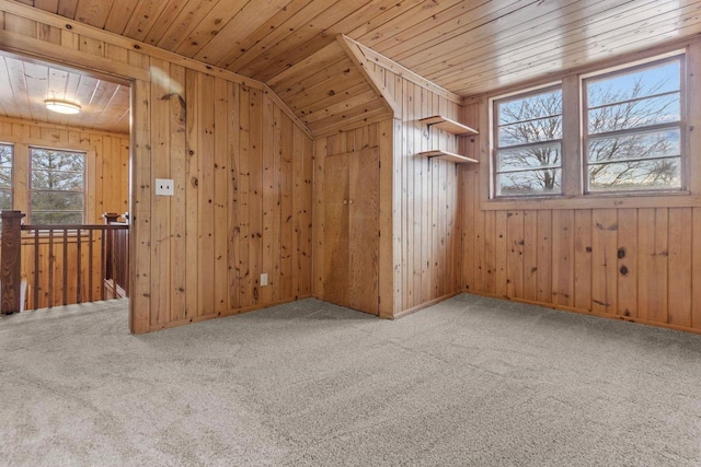 bonus room with lofted ceiling, carpet, wood walls, and wooden ceiling