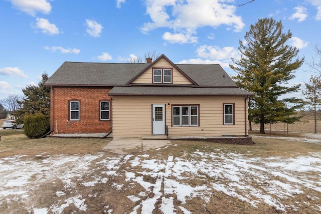 snow covered property featuring a patio