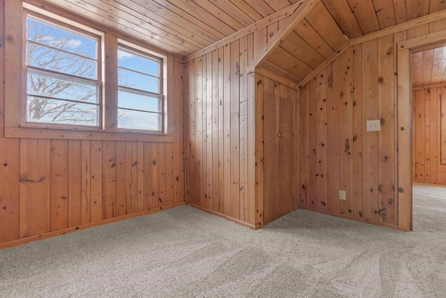 additional living space featuring vaulted ceiling, wooden ceiling, light carpet, and wooden walls