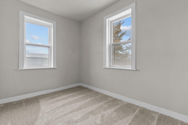 empty room with a healthy amount of sunlight and carpet flooring