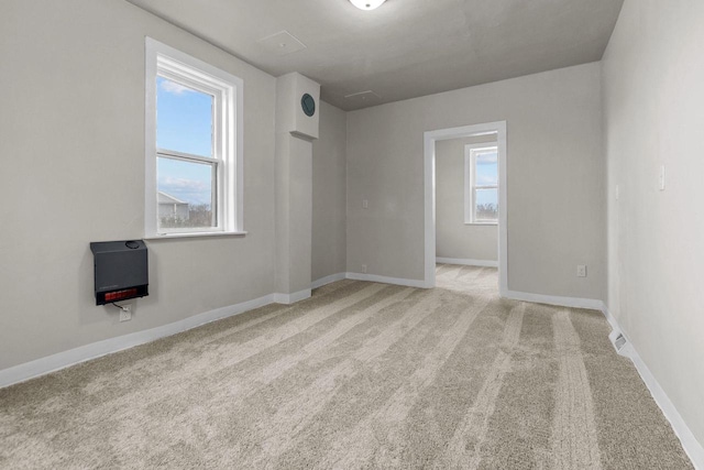 spare room featuring light colored carpet