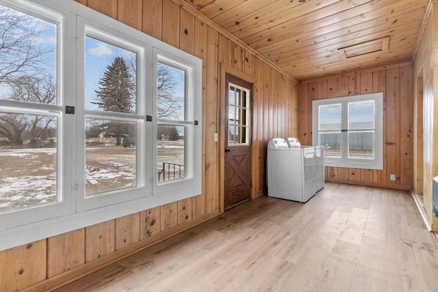 washroom featuring separate washer and dryer, a wealth of natural light, wood ceiling, and light wood-type flooring