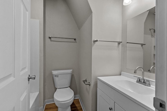 full bathroom featuring tub / shower combination, lofted ceiling, vanity, toilet, and hardwood / wood-style flooring