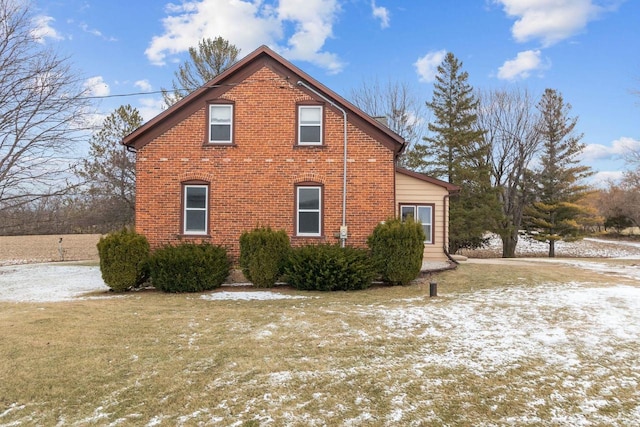 snow covered property featuring a lawn